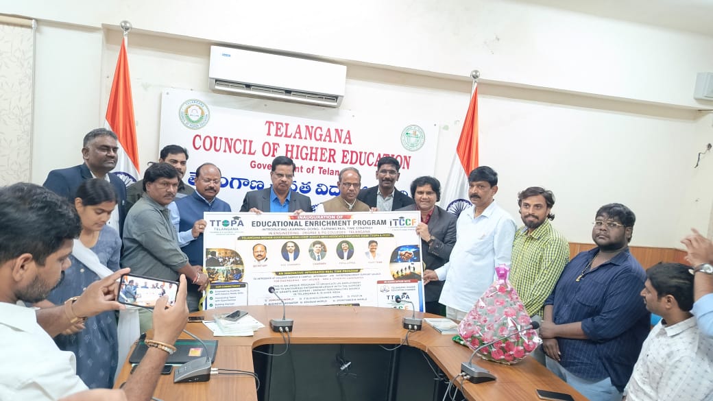 Officials and the team holding the Educational Enrichment Program banner