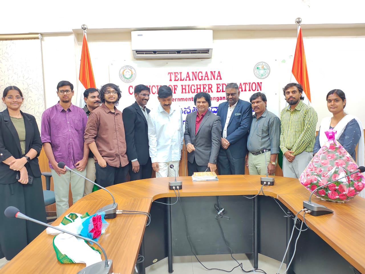 Students and officials standing behind the conference table at the Telangana Council of Higher Education